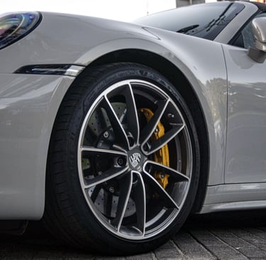 an Enlab porsche 911 gts parked on a sidewalk