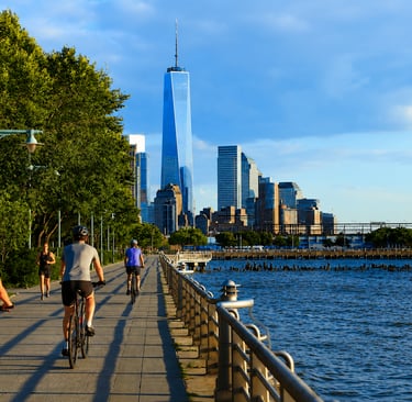 Cyclists riding beside the river on the Hudson River Greenway in New York