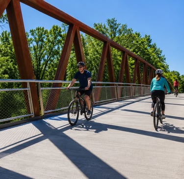 Cyclists riding across a bridge on the Louisville Loop in Kentucky