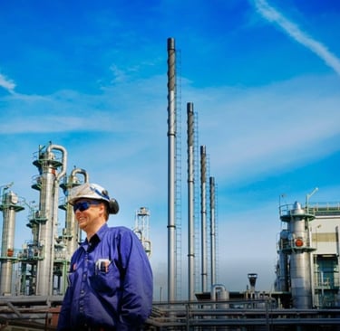 Durraniz Consultants' staff in blue uniforms standing in front of a oil and gas plant