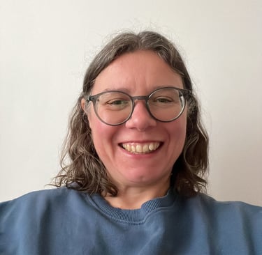 a woman with glasses and a blue shirt