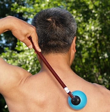 a man with a blue ball on his back and a blue ball on his neck