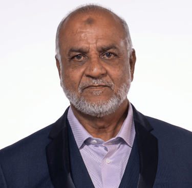Professional headshot of a senior man with a grey beard wearing a navy blue suit jacket.