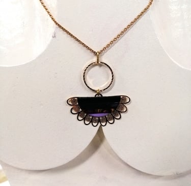 a necklace with a purple and gold necklace