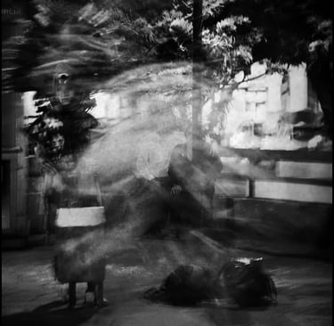 a man sitting on a bench in a park