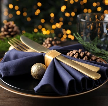 a plate with a gold fork and knife on it