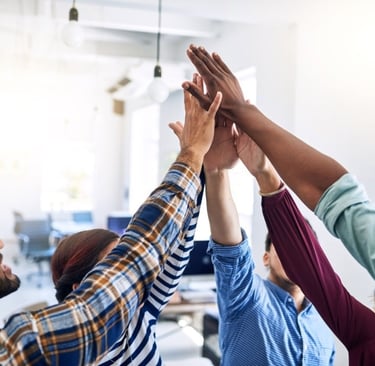 a group of African people holding hands up in the air