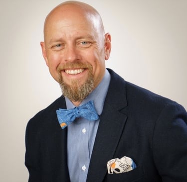 a man in a suit and bow tie