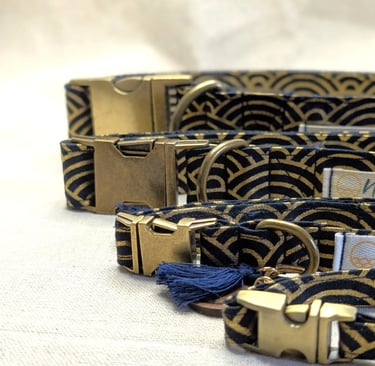 Elegant navy and gold wave pattern dog collars with brass buckles and tassels.