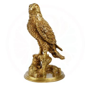 a golden eagle sitting on a tree stump