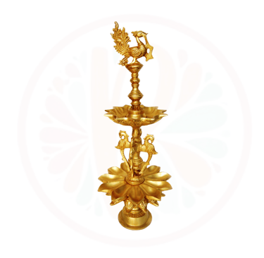 a tall gold colored candle holder with a bird on it