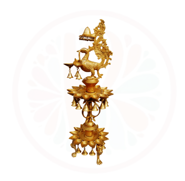 a golden colored clock with a bird on it