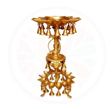 a gold candle holder with bells and bells