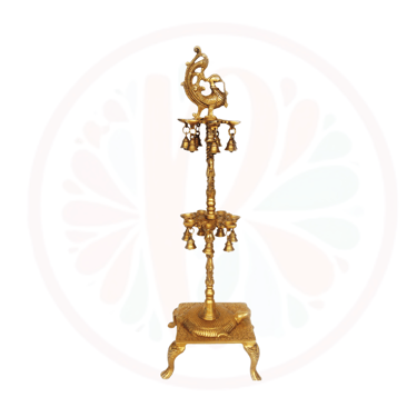 a gold - plated candle holder with bells