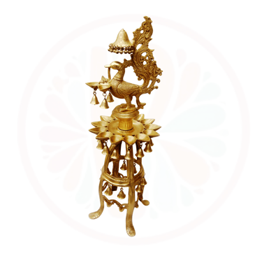 a gold colored clock with a bird on top of it