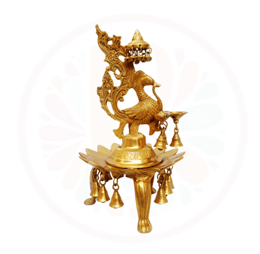 a golden colored candle holder with a dragonfly on it