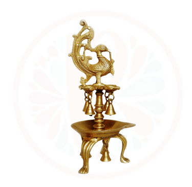 a gold colored peacock on a stand with a gold colored peacock