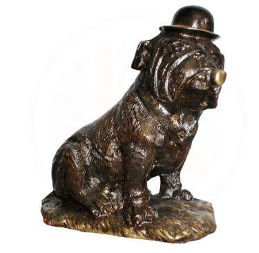 a statue of a brass dog sitting on a rock