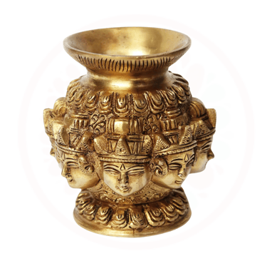 a gold vase with a face of a durga with many faces on it