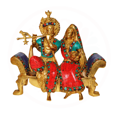 a statue of aradha krishna sitting on a bench