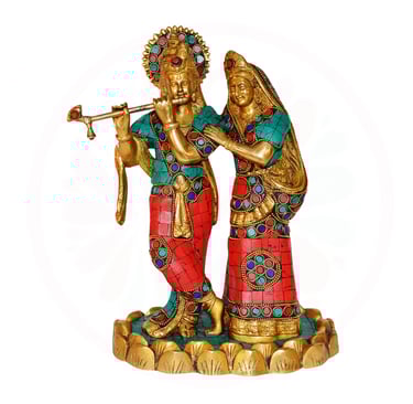 a statue of a radha and krishna playing flute
