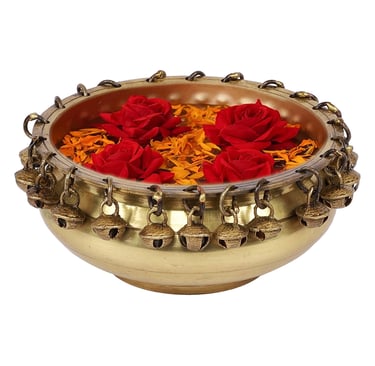 a bowl of flowers in a gold bowl