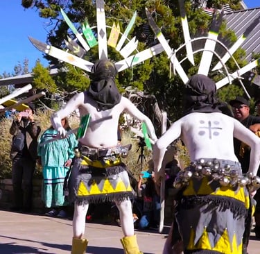 people in ceremonial costumes performing on at Grand Canyon National Park
