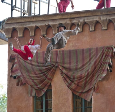 a woman and man jumping off a roof