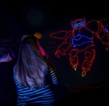 a woman watch a drones show at disney springs