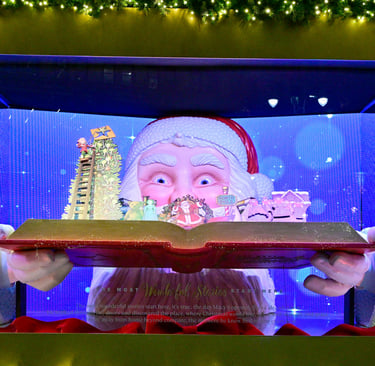 a santa clause is holding a book and smiling