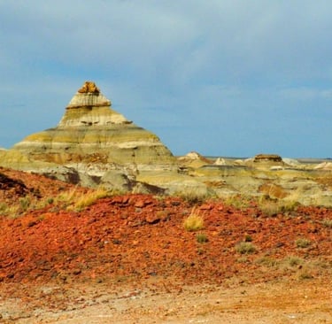 a rock formation in the desert with a blue sky