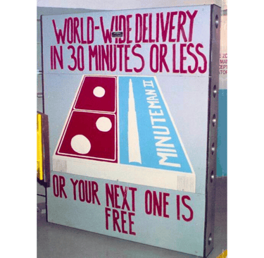 a sign on a blast door that says world wide delivery in 30 minutes or less