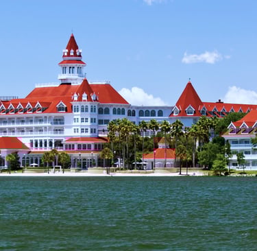 a large white building with a red roof and a tower