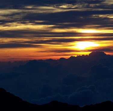 a sunrise with a sun rising over a mountain range