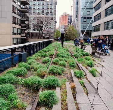an elevated train track made into a park with people walking