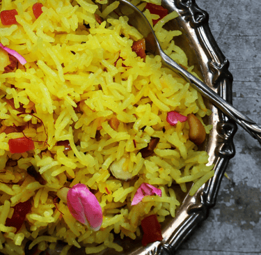 a bowl of saffron rice with a spoon