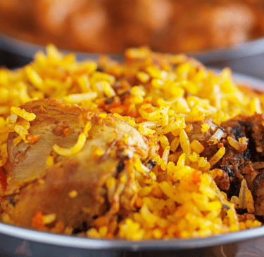 a bowl of food with a chicken and rice rice