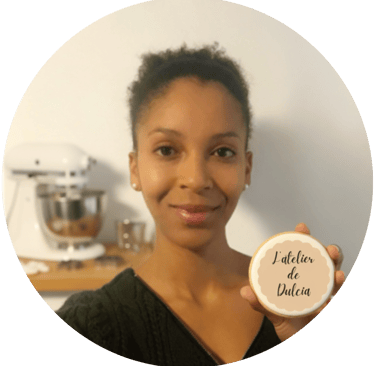 une femme qui tient un biscuit personnalisé dans sa main