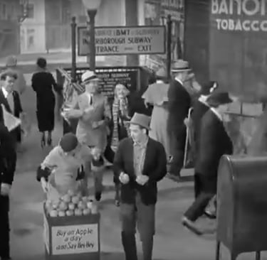 Street scene from 42nd Street (1933) finale with vendors, police, and Depression‑era city life.