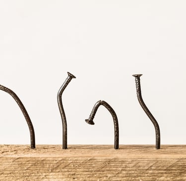 a group of nails on a piece of wood secret addiction