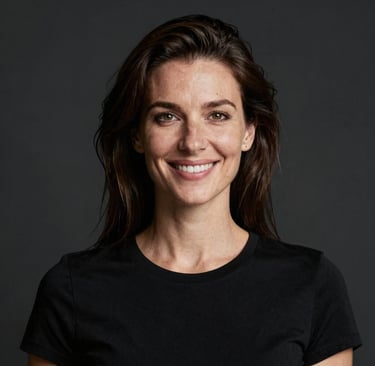 Portrait of a smiling woman with short hair in a cozy office setting.