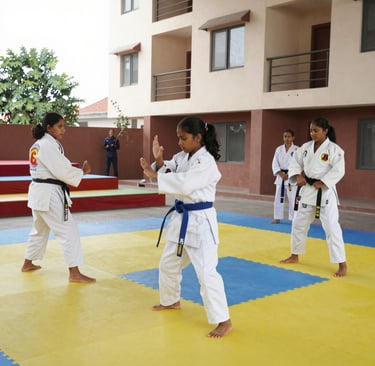 An instructor demonstrating self-defense moves to a small group in a bright studio.