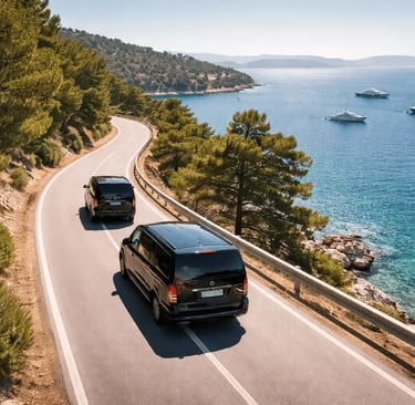 Two black Mercedes Vito minivans driving along the Athens Riviera coast with luxury yachts