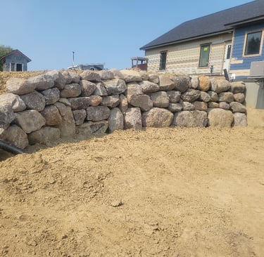 boulder wall behind residential home