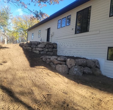 boulder wall behind home
