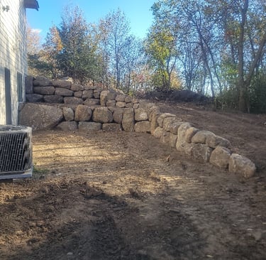 boulder wall next to residential home