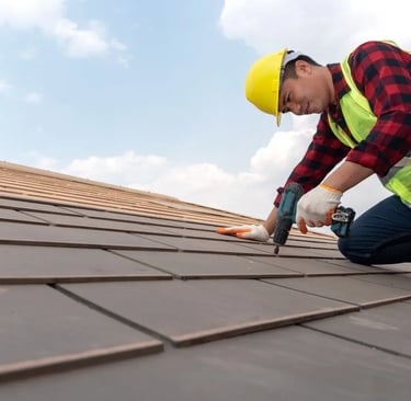 a roof worker is using a drill to fix the roof