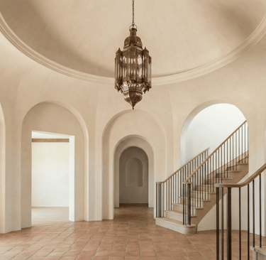 high end foyer with round soffit and double staircases