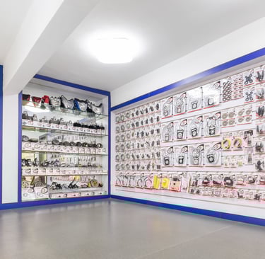 Wide selection of motorcycle lights and spare parts displayed in a wholesale  showroom shop.