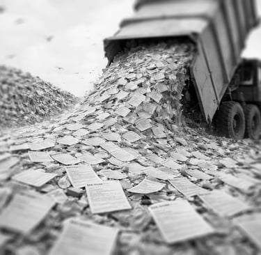 garbage truck dumping tons of paper resumes on a garbage dump